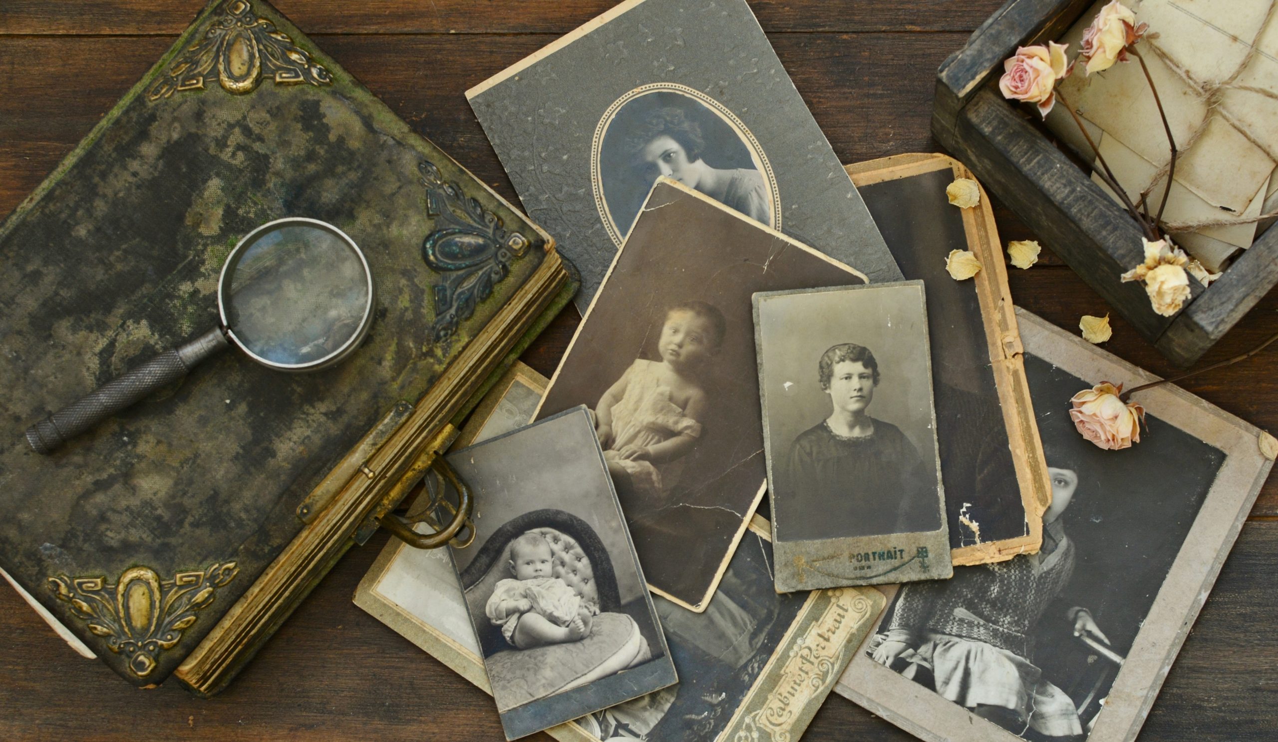 Still-life with old photo album and historical photos of family