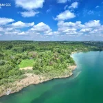 Luftaufnahme einer exklusiven Alleinlage am See mit umgebender Natur und Wald
